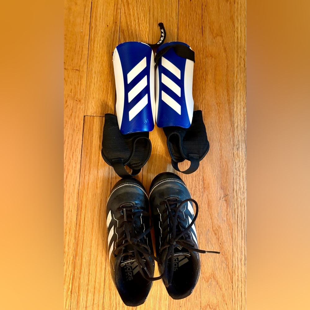 Adidas Kids Black and White Athletic Shoes with Blue Shin Guards